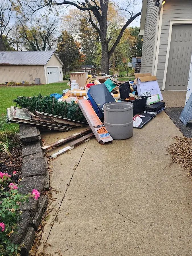 Dumpster being loaded with debris for Estate Cleanout Dumpster Rental in East Porterville